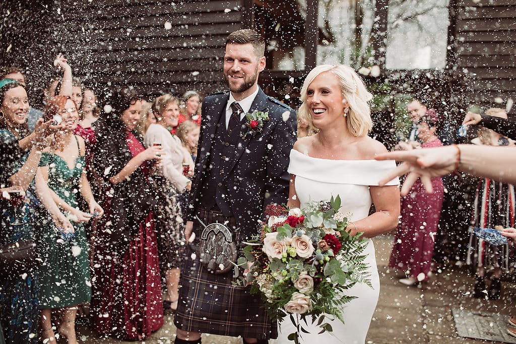bride and groom at winters barns with white confetti fluff
