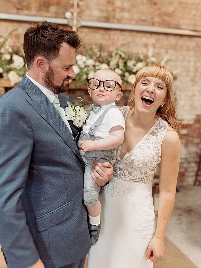 couple with baby wearing glasses at botley hill barn wedding venue