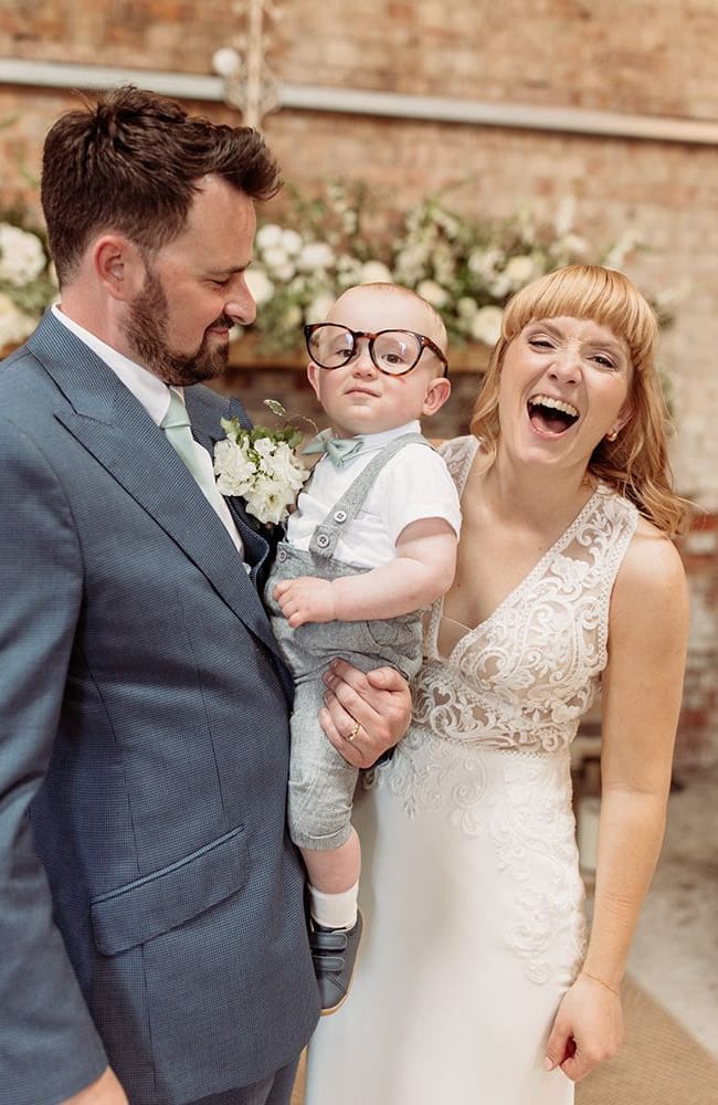 couple with baby wearing glasses at botley hill barn wedding venue
