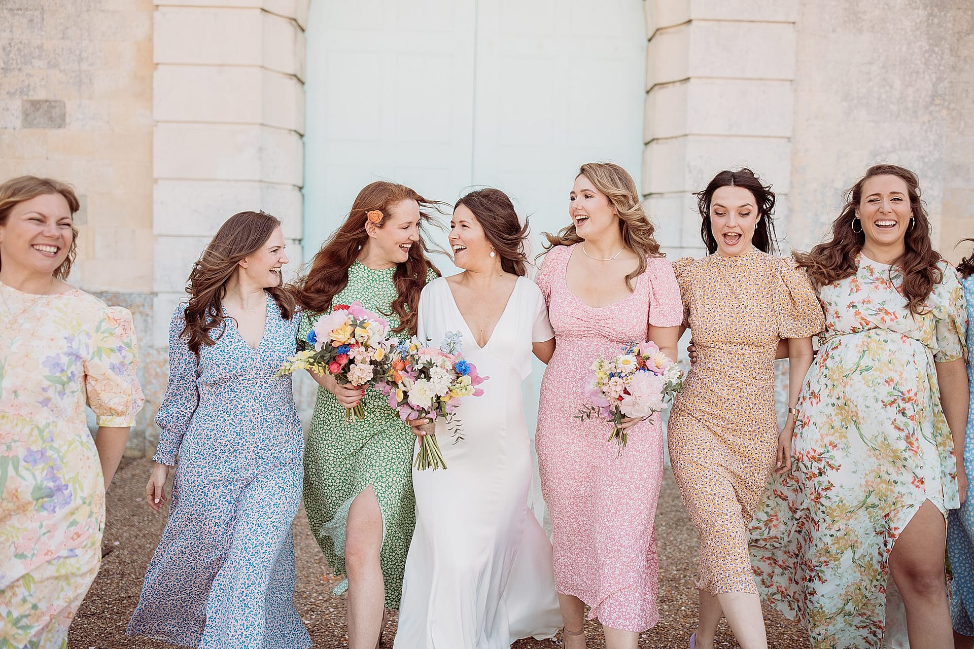 Bridesmaids in colourful dresses at Firle place wedding venue