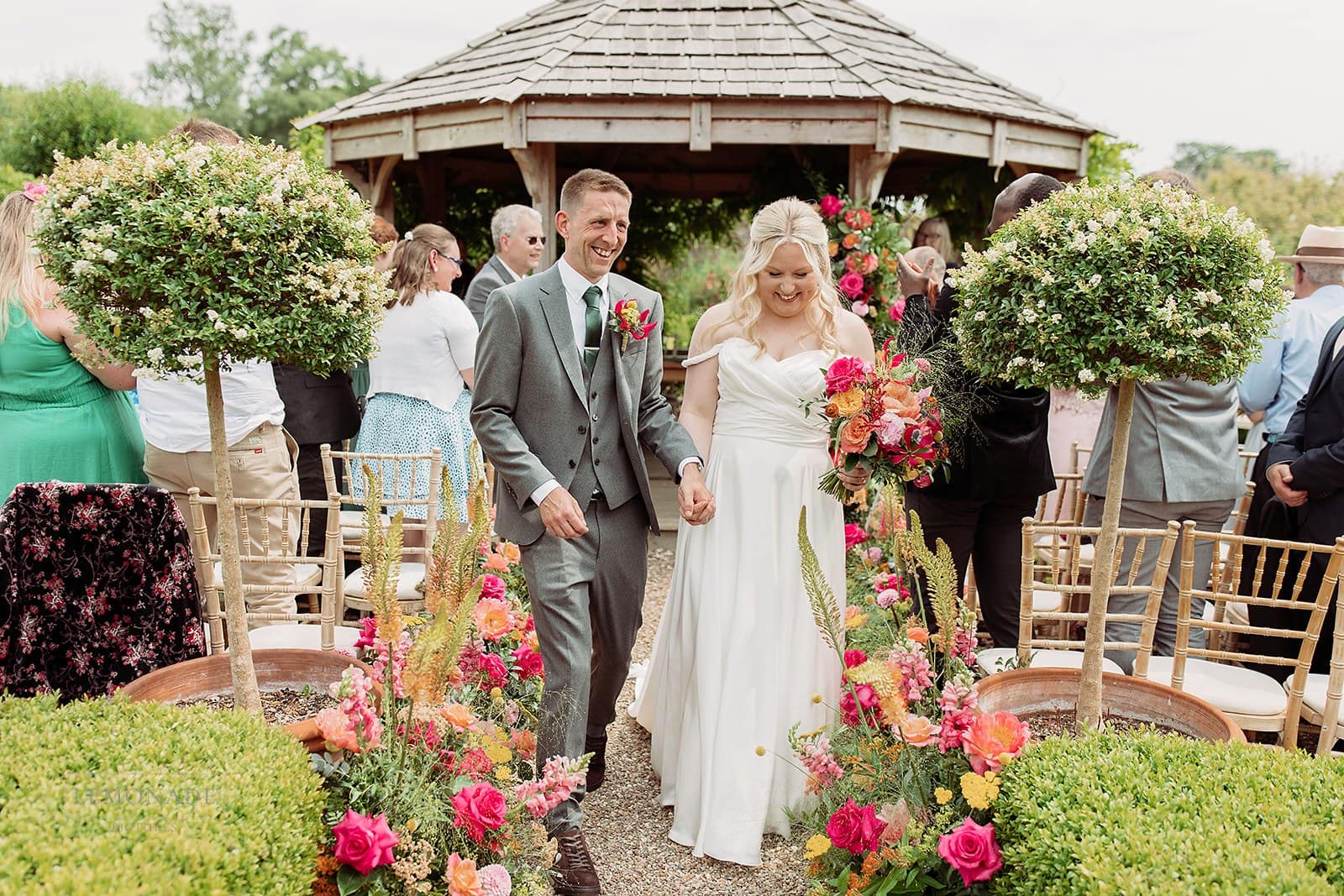 bride and groom walking down the aisle at their secret garden ashford wedding