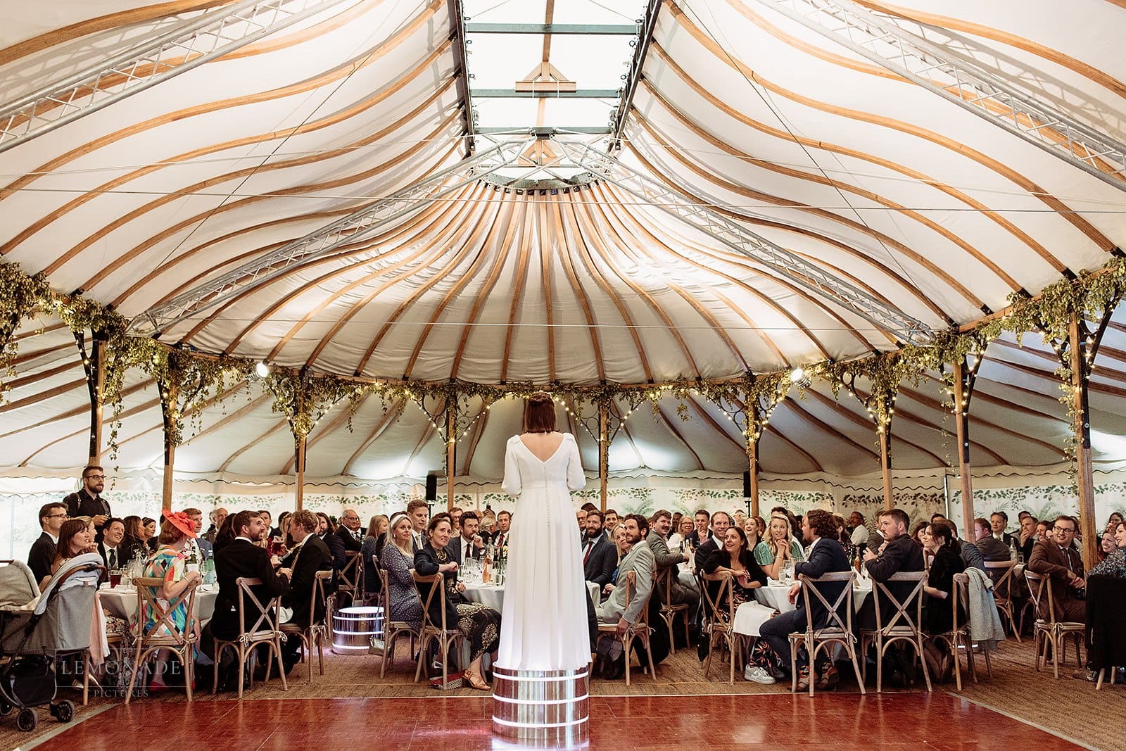 bride doing speech in Bohemia canvas marquee at this diy garden wedding